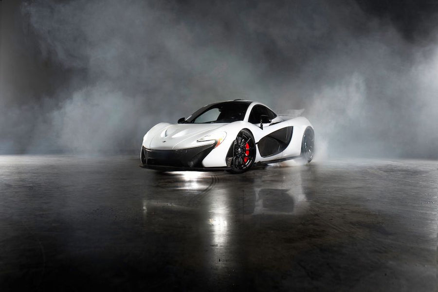 white McLaren P1 creating smoke