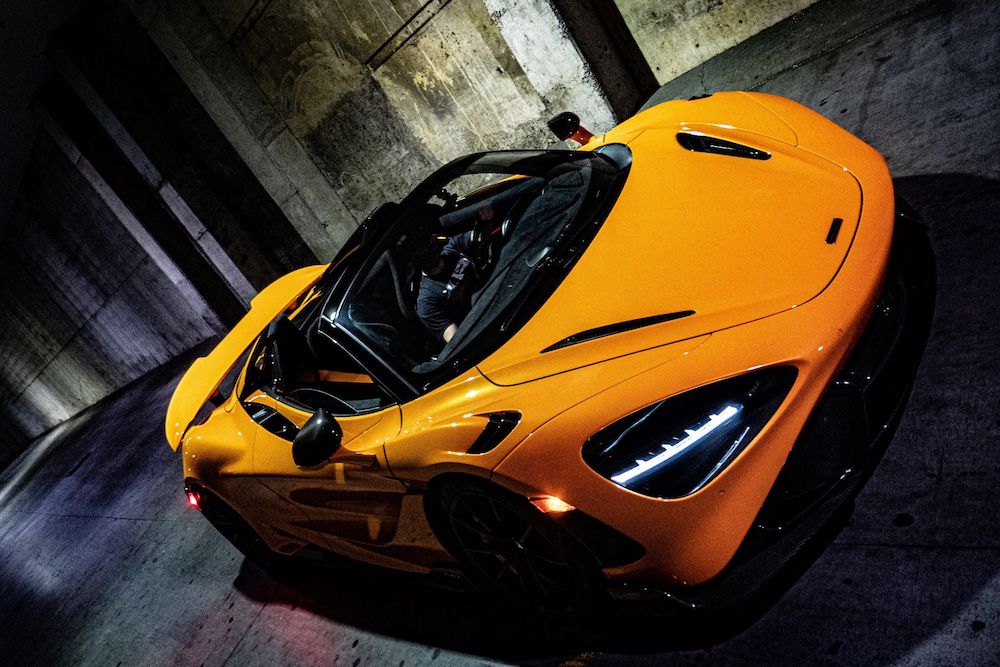 yellow sports car in a dark alley at night
